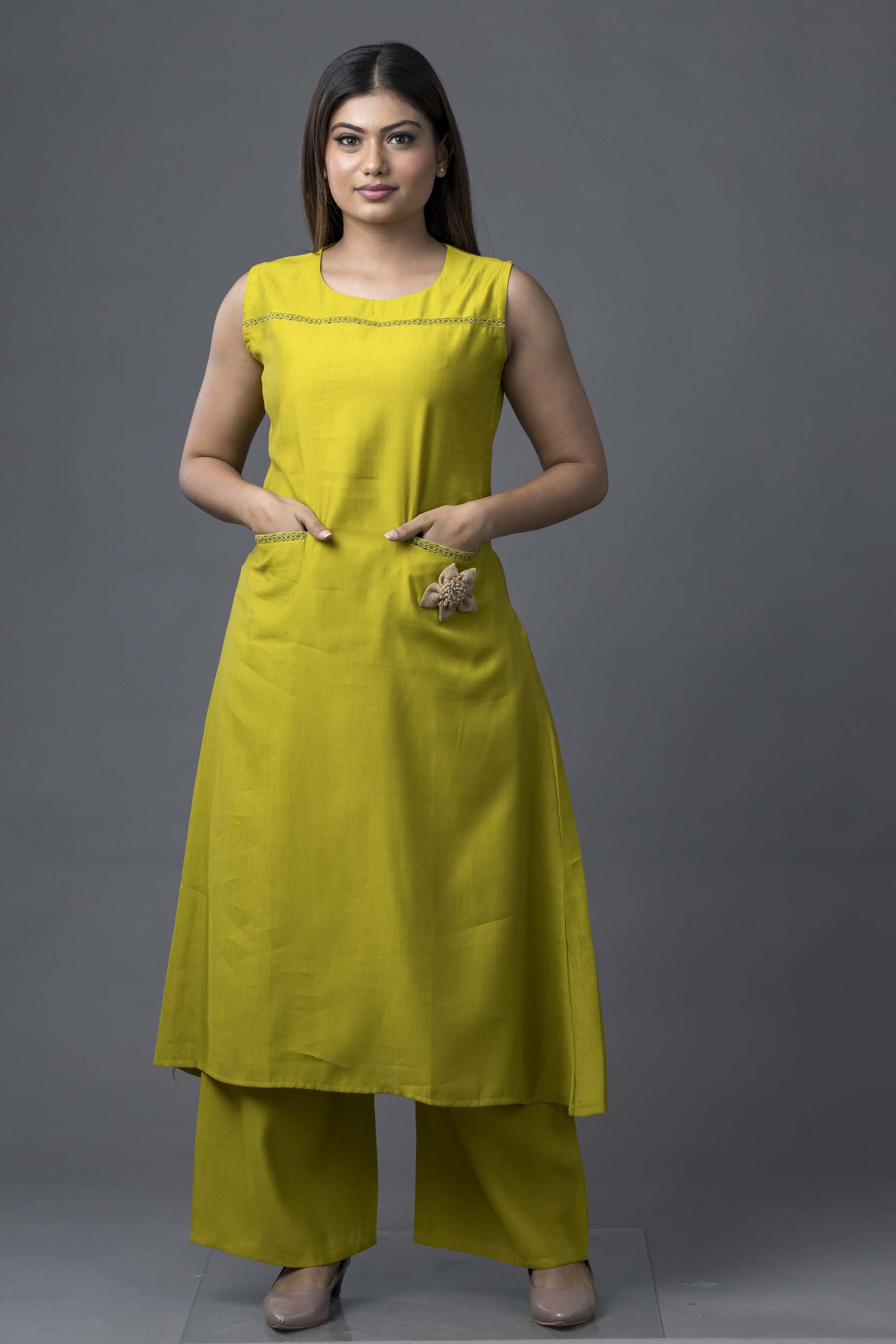 Woman wearing a yellow outfit against a gray background